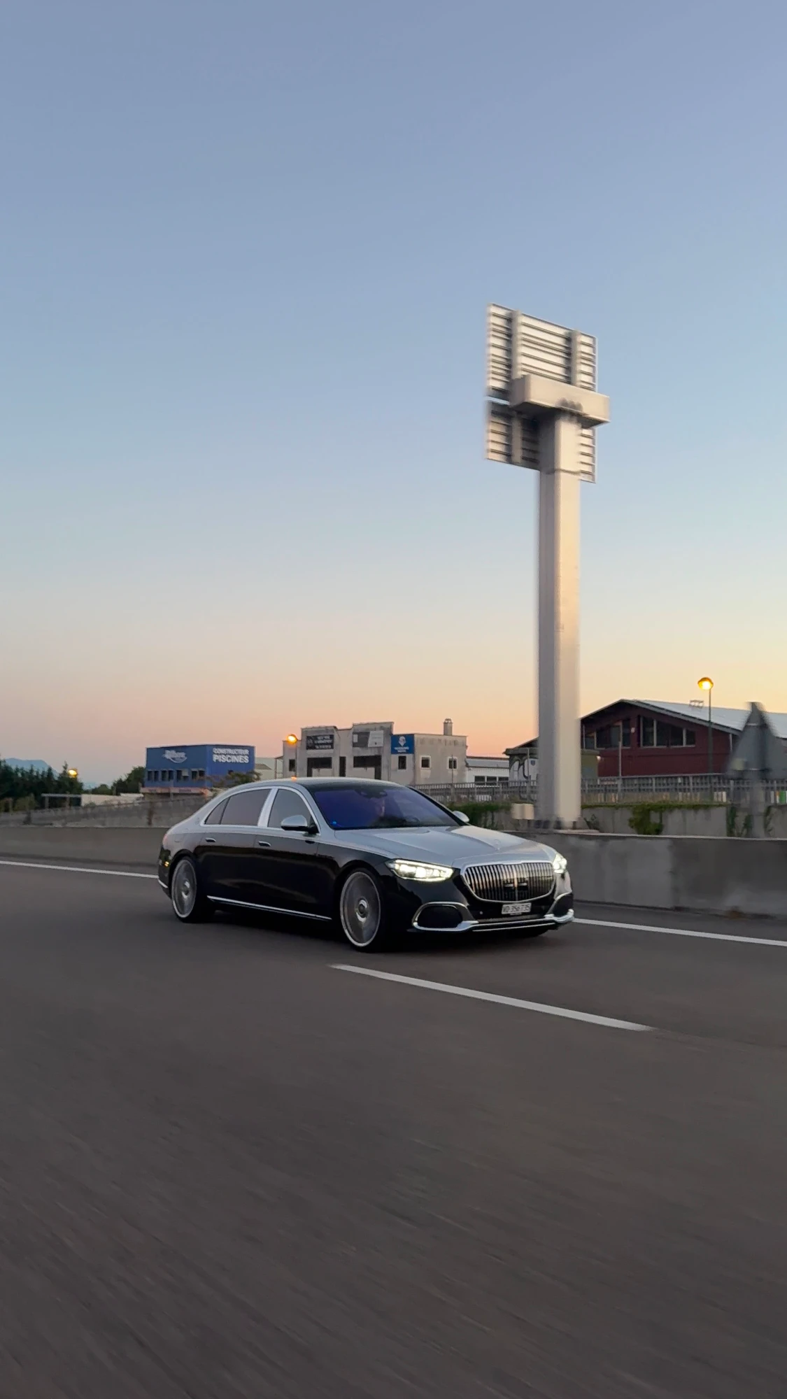 Private chauffeur for Zürich Airport transfer, Mercedes-Maybach S-Class on the airport road at dusk