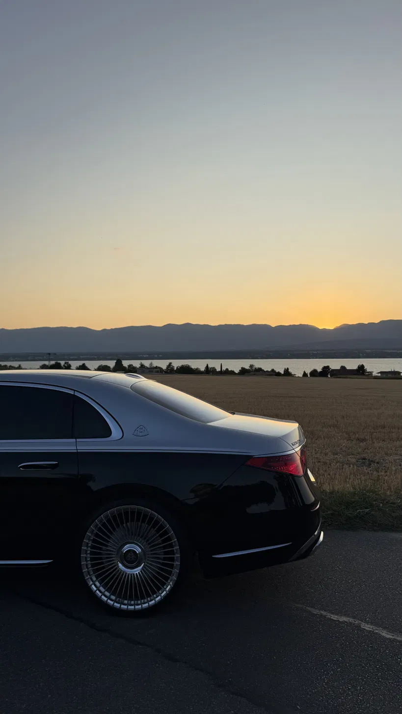 Private chauffeur from Geneva to Villars-sur-Ollon, Mercedes-Maybach by Lake Geneva at sunset
